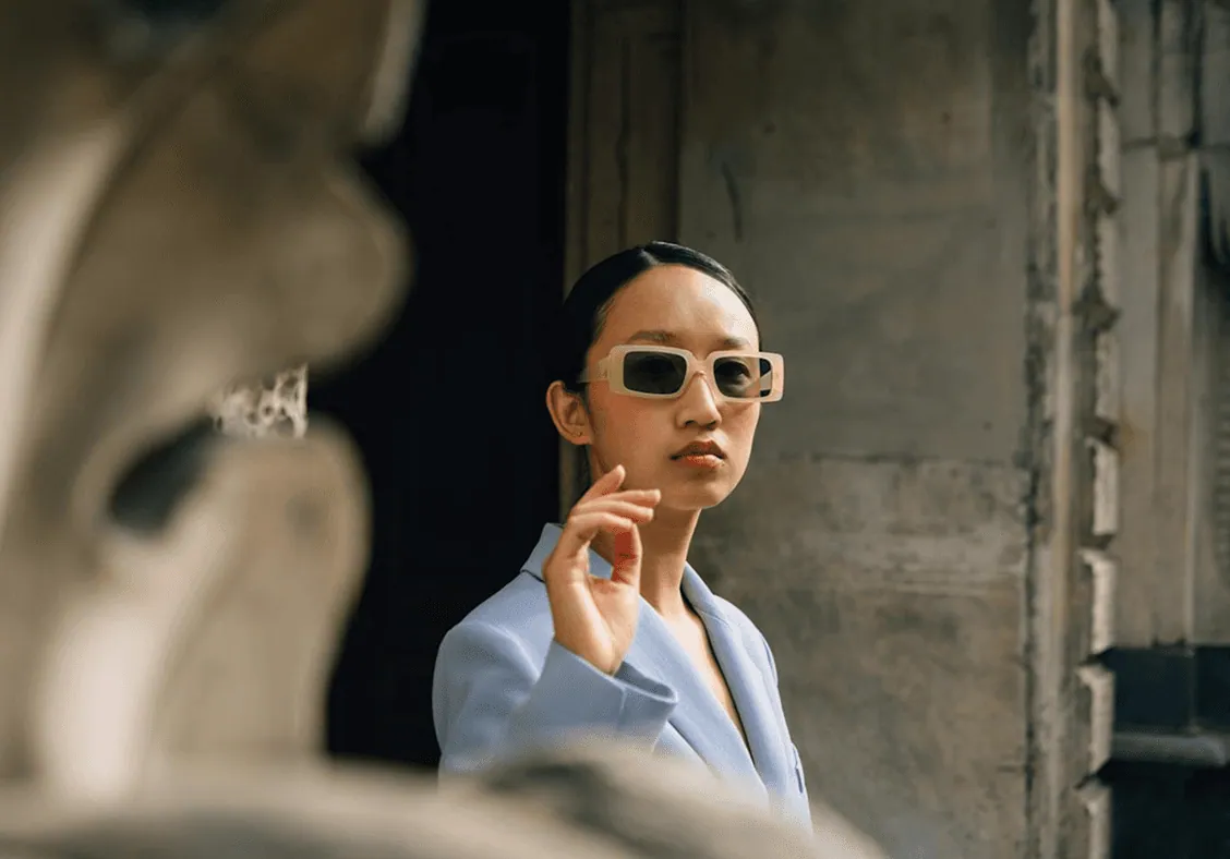 A woman in sunglasses outside a building